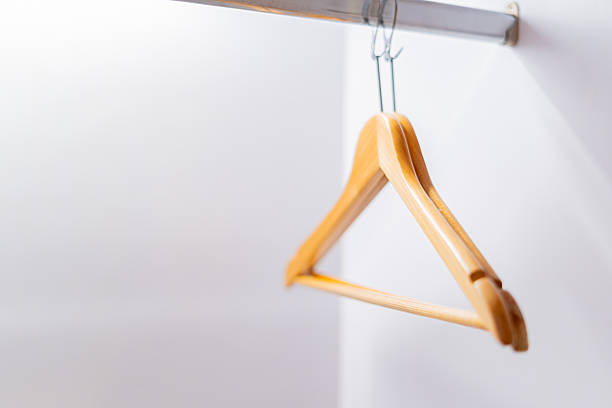 istock Clothes hangers are hanging on a rail in the wardrobe. 2209576212