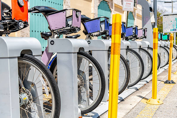 A group of electric bicycles for rent on a street corner in downtown Fort Lauderdale, Florida.