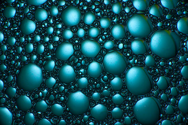 istock Abstract texture with drops of oil and soap on the water surface 2209576564
