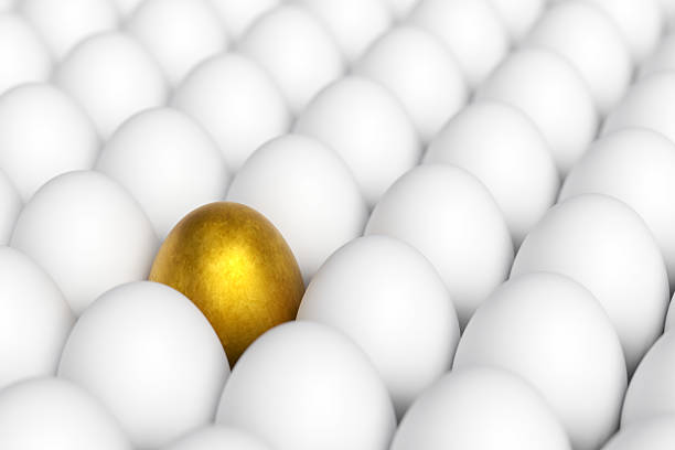 istock Individiuality and difference concept.Standing golden egg in between common eggs. 2209577864