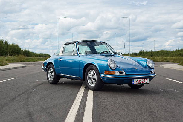 Vilnius, Lithuania - August 10, 2023: Front view of 1971 Porsche 911T Targa in a metallic blue. Car parked in the middle of a closed four lane road. Car is in perfect condition, after full restoration.