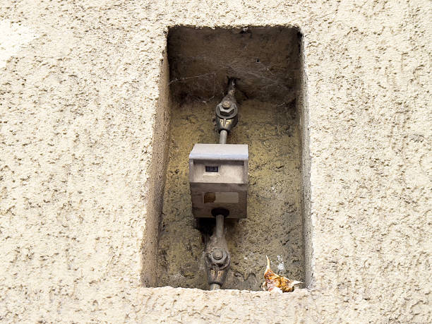istock Outdoor wall-mounted electrical meter box on textured surface with cobwebs 2209580161
