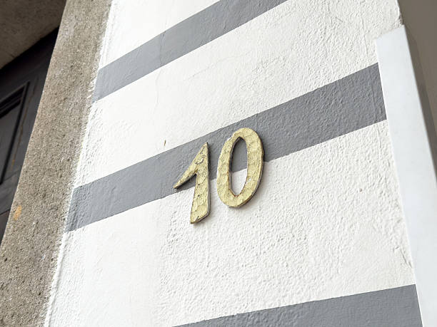 istock Weathered number 10 on striped building wall 2209580187