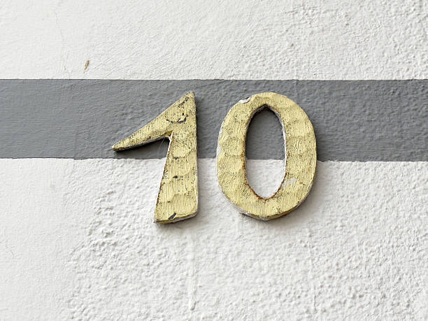 istock Weathered number ten on textured gray and white wall 2209580188