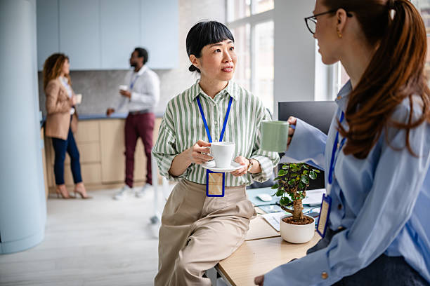 istock Team members engage in meaningful discussion over coffee in a modern office environment 2209580218