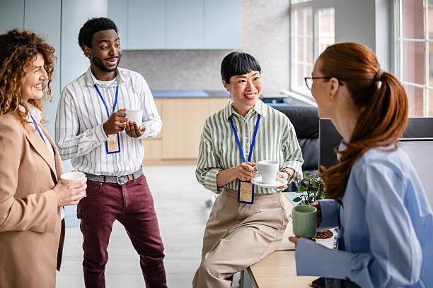 istock Team members engage in a productive discussion over coffee in a modern office environment focused on collaboration and diversity 2209580384