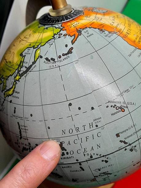 istock North Pacific Ocean subtitle, text or word on globe pointing with finger 2209580813