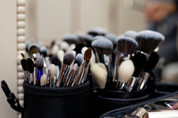 istock Makeup artist applying cosmetics to model in home studio 2209581134