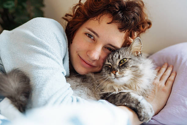 istock sleeping young woman on bed with pet cat 2209581241