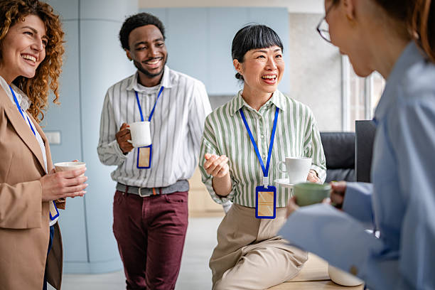 istock Team of diverse business professionals collaborating in a modern office setting while enjoying a joyful discussion over coffee 2209581865