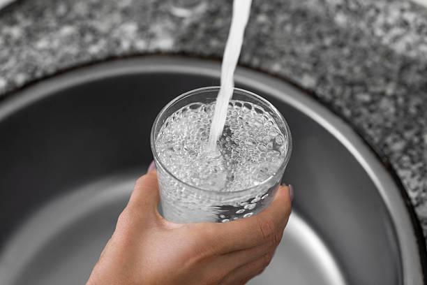 Unrecognizable female pouring tap water
