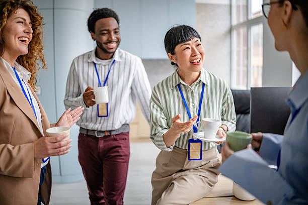 istock Cheerful diverse team enjoying coffee break in a modern office environment while discussing ideas and fostering collaboration 2209581934