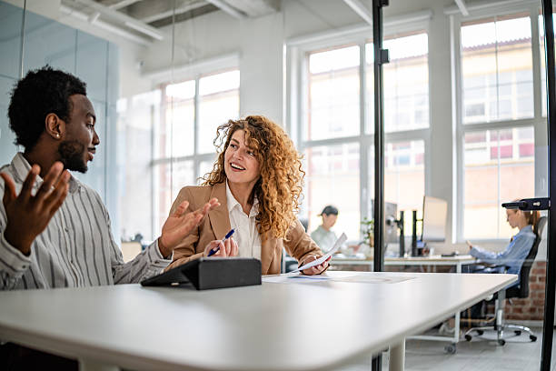 istock Engaged teamwork in a modern office with a focus on collaboration and positivity among diverse professionals 2209582355