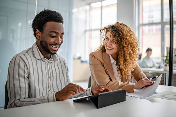 istock Cooperative professionals engaged in discussion and planning in a modern office environment 2209582460