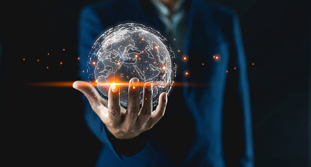 istock Businessman holds a glowing, digital globe symbolizing technology, innovation, and global connectivity in a dark setting. 2209582964