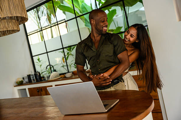 istock Happy couple sharing a moment together while working at home in a modern kitchen 2209584611