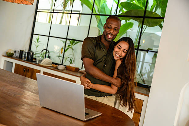 istock Couple embracing while enjoying a moment together in a modern home kitchen 2209584626