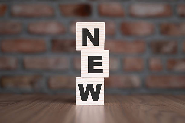 New word with wooden blocks on table