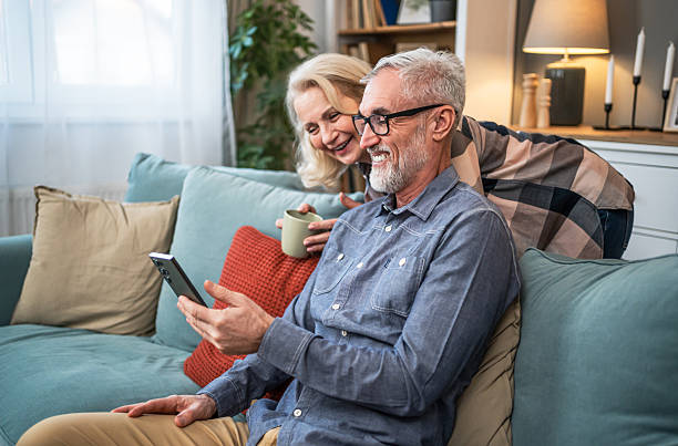 istock Senior couple looking together at mobile phone 2209588833