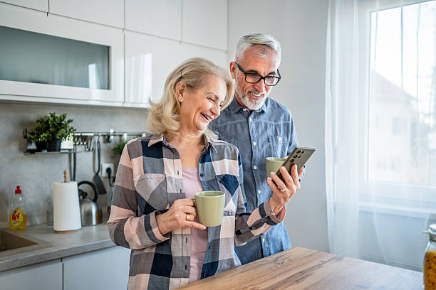 istock Mature couple using smartphone in the kitchen 2209588919