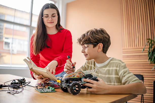istock Kids engaging in innovative robot design during a robotics class, fostering creativity and collaboration 2209590196