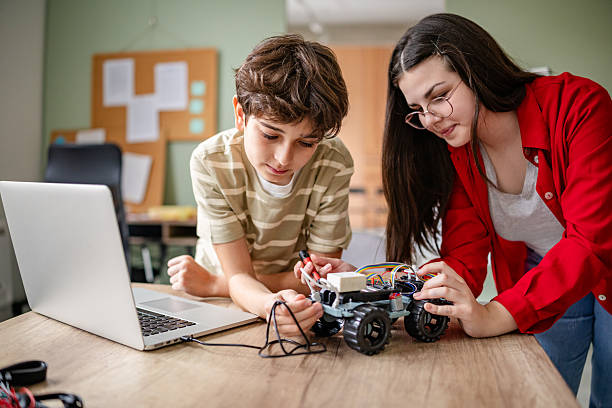 istock Kids collaborating on innovative robot design in an engaging robotics class 2209592284