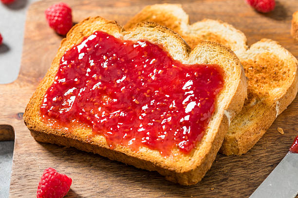 istock Sweet Homemade Raspberry Jam Jelly on Toast 2209592299