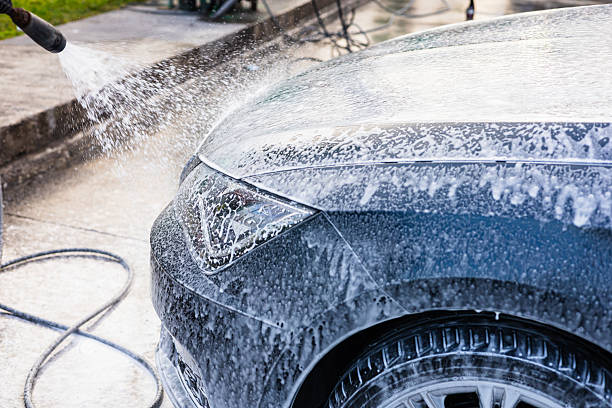 istock Car wash process showcasing foam being sprayed on a vehicle at an auto detailing location 2209592462