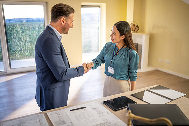 istock Professional Real Estate Agent and Client Handshake During Property Viewing in Sunlit Room 2209592601