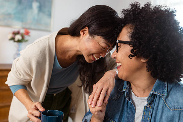 Happy lesbian couple sharing a joyful moment at home