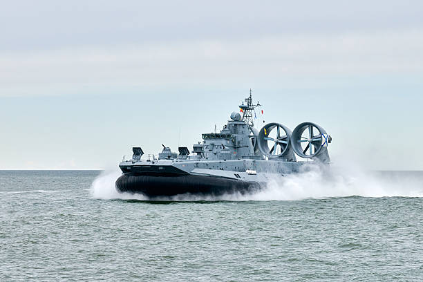 istock Hovercraft warship armed with armament sails into sea toward military target to attack and destroy 2209596257