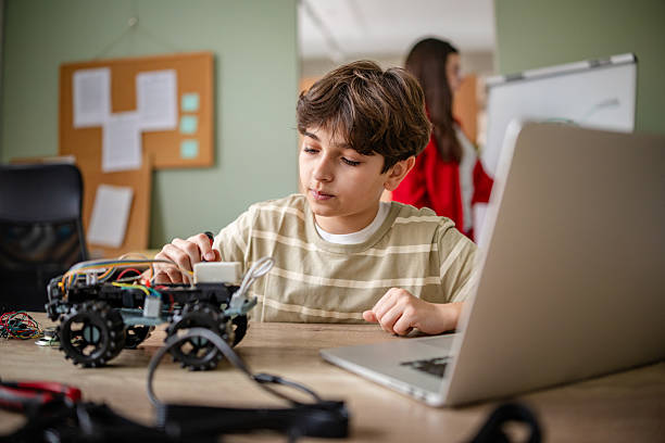 istock Kids engage in robotics class designing and building robots during back to school activities 2209596337