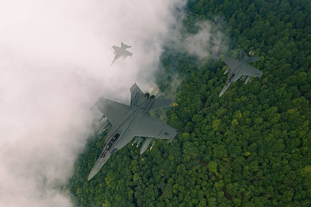 istock F-15 Fighter Jets flying over forest. 2209597636