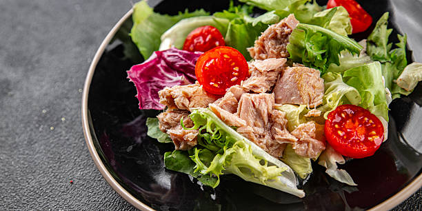istock Tuna salad canned fish mixed green leaf lettuce seafood appetizer vegetable dish organic fresh tasty gourmet food background on the table rustic top view copy space vegetarian food pescetarian diet 2209599214