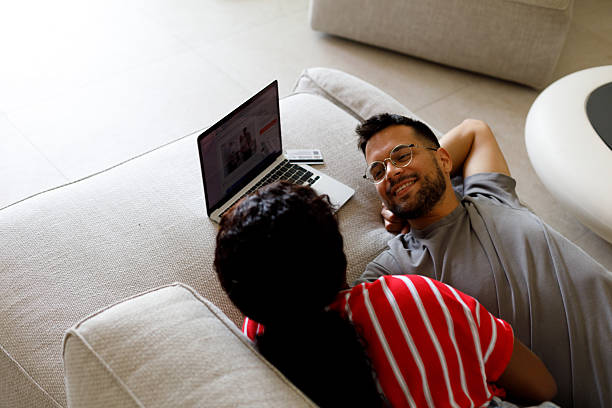 istock Multiethnic couple using laptop at home 2209599315