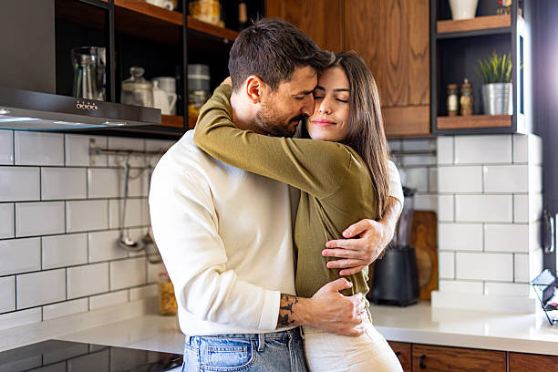 istock Loving Couple Embracing Tenderly in Modern Kitchen 2209599449