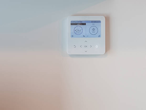 istock Modern Digital Thermostat Mounted on a Minimalist Wall for Temperature Control 2209599565
