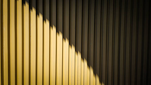 istock Light and shadow create geometric shapes and divide the wall into two parts 2209601273