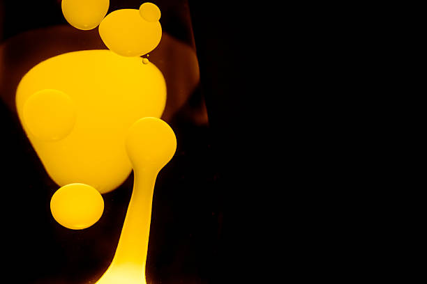 Yellow lava lamp, black background, horizontal format with copy space