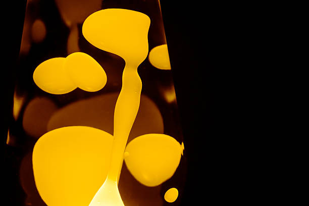 Yellow lava lamp, black background, horizontal format with copy space