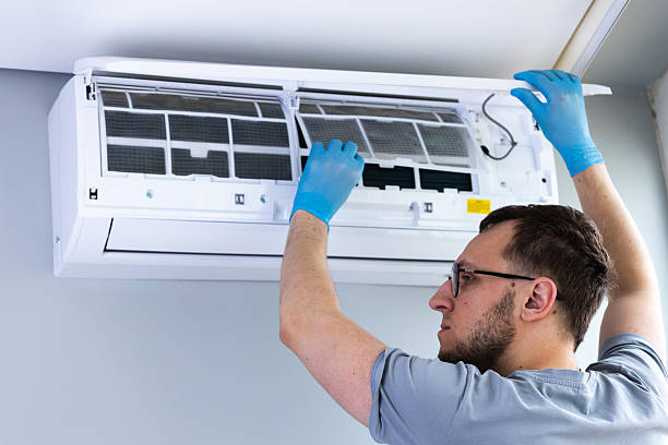 istock A Skilled Technician Performing Maintenance on an Air Conditioning Unit While Wearing Blue Protective Gloves and Carefully Inspecting the Filters Inside the System 2209607315
