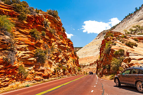 Zion Park,  Utah - May 15, 2021: Driving through Zion National Park, located in Utah state, includes mountains, canyons, buttes, mesas, monoliths, rivers, slot canyons, and natural arches.