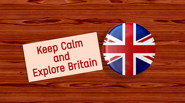 istock Keep Calm and Explore Britain text message on paper. UK flag badge,wooden surface, 3D render. 2209609520