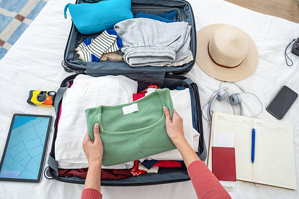 istock Travel prep, packing clothes in suitcase 2209610828