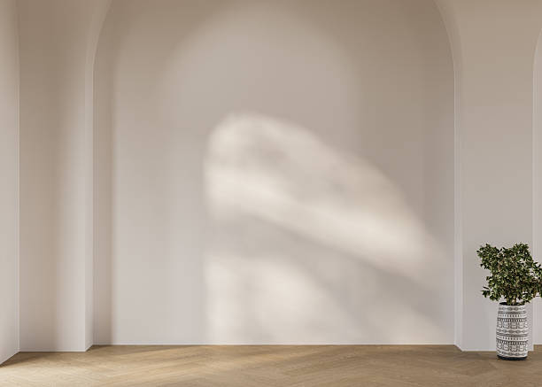 istock Bright empty room with a focus on natural materials, including wood flooring and an arched wall. Sunlight adds warmth to the clean, open space. 3D rendering 2209610974