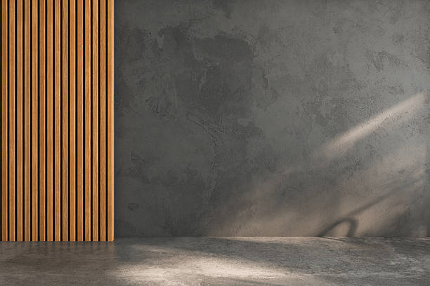 istock Empty room with a concrete wall and wooden slats, illuminated by soft natural light and shadows. Ideal for design mockups, presentations, or creative projects requiring a minimalist setting. 2209610985