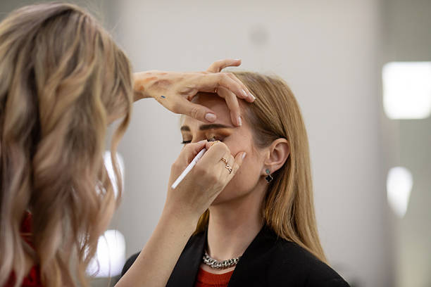 istock Businesswoman getting makeup done by makeup artist 2209611304