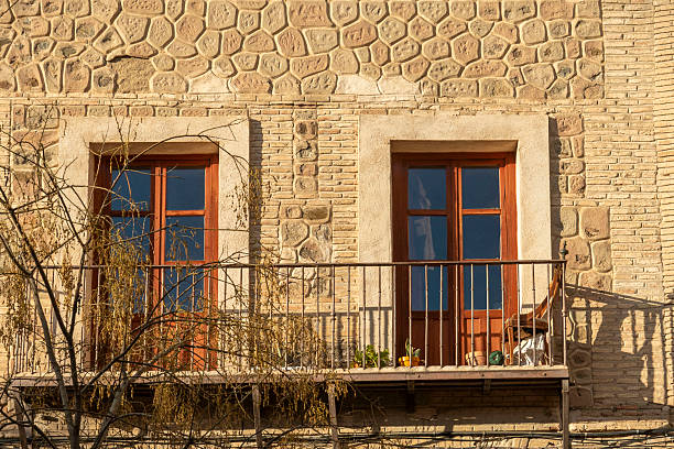 A charming brick building that features a delightful balcony and a sturdy door, bringing character to the structure itself