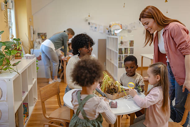 Diverse preschool children explore gardening and nature with teachers, using soil and plants for a fun hands-on learning activity focused on environmental awareness and teamwork.