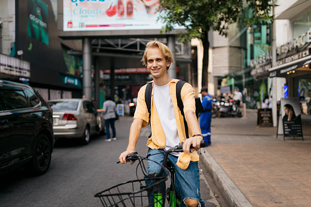 Urban cyclist walking along a street.